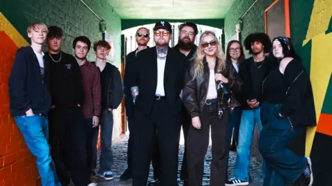Echoes of Adolescence: Lottery Winners Harmonize with Youthful Odes to Leigh